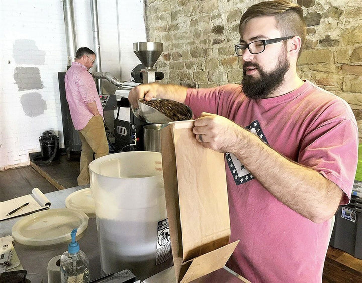 Spaceship Earth Coffee Owner Measuring Out Beans