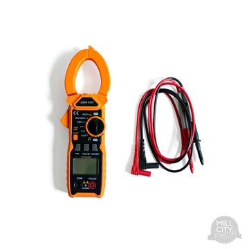 Digital clamp multimeter next to the included electrical probes