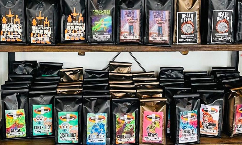 A wide variety of brightly colored Weird Brothers packaged coffee sit on a shelf